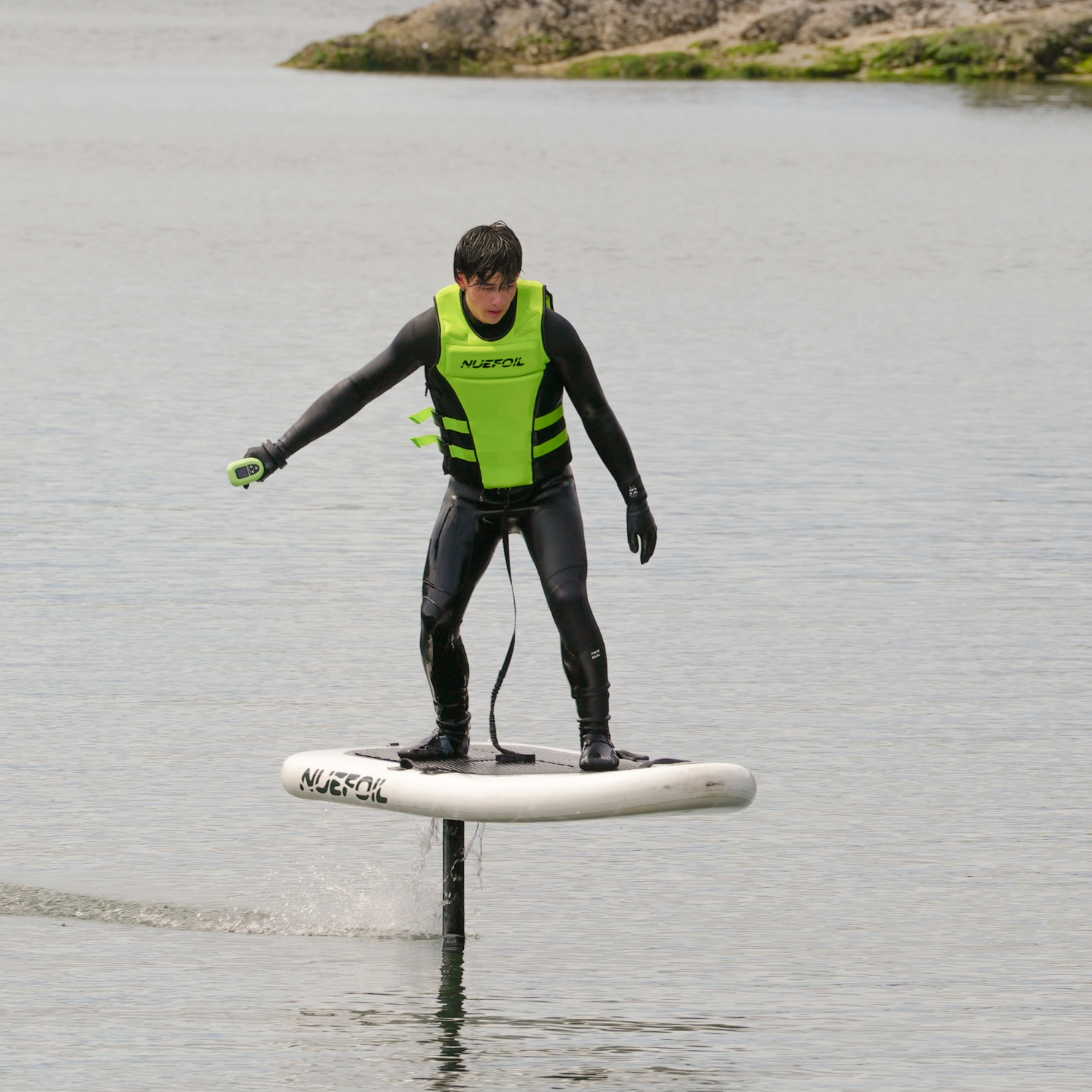 Person on a eFoil on a body of water with a scenic background